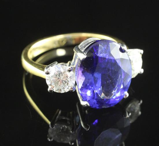 An 18ct gold, tanzanite and diamond three stone ring, size N.